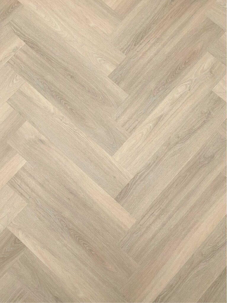 Light wood herringbone pattern flooring